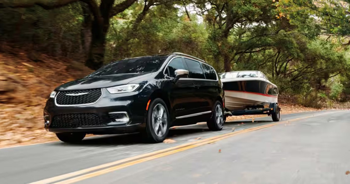 Image of a black Chrysler Pacifica towing a boat.
