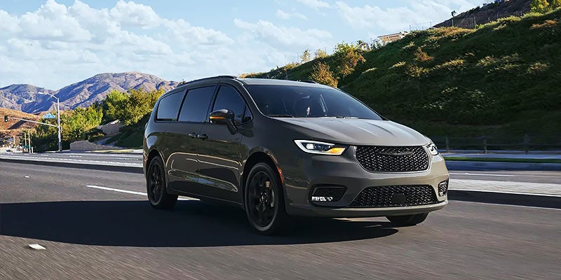 Pre-owned minivan with sliding door open parked at Cable Dahmer CDJR of Kansas City